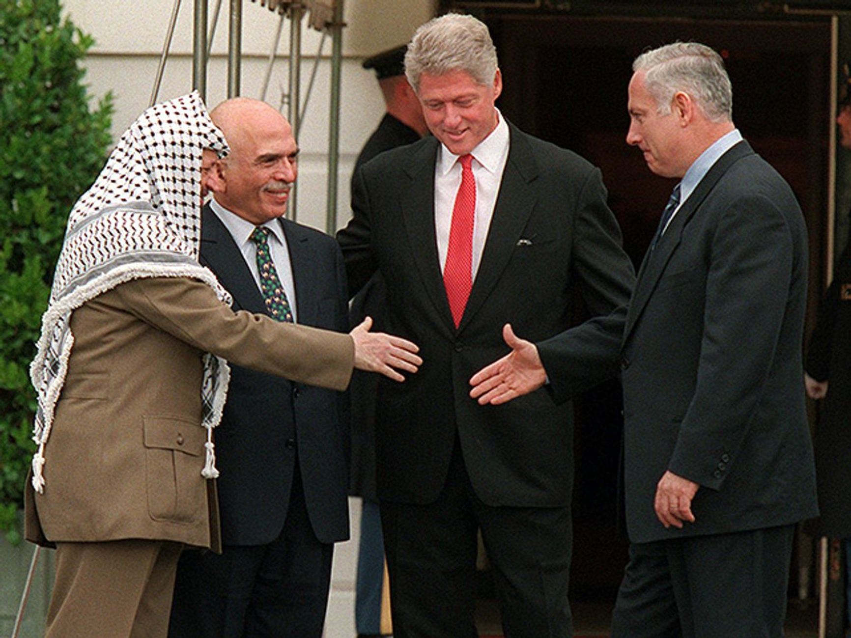 PLO leader Yasser Arafat, King Hussein of Jordan, U.S. President Bill Clinton, and Israeli Prime Minister Benjamin Netanyahu, 1996